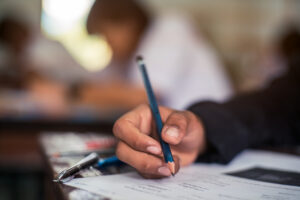 Hand of Student doing test or exam in classroom of school with stress.16:9 style