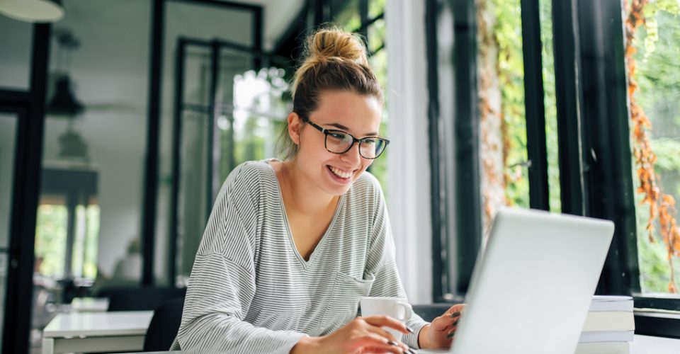 Girl in casual clothing using laptop.