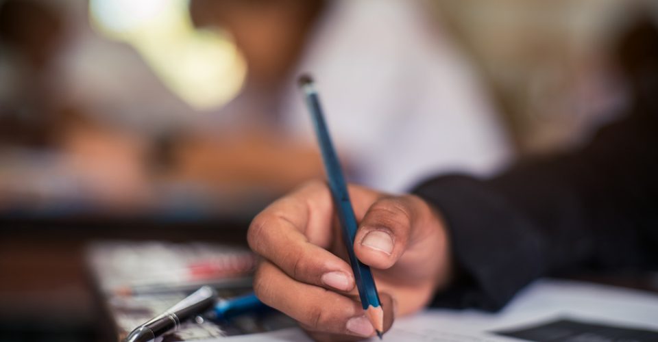 Hand of Student doing test or exam in classroom of school with stress.16:9 style